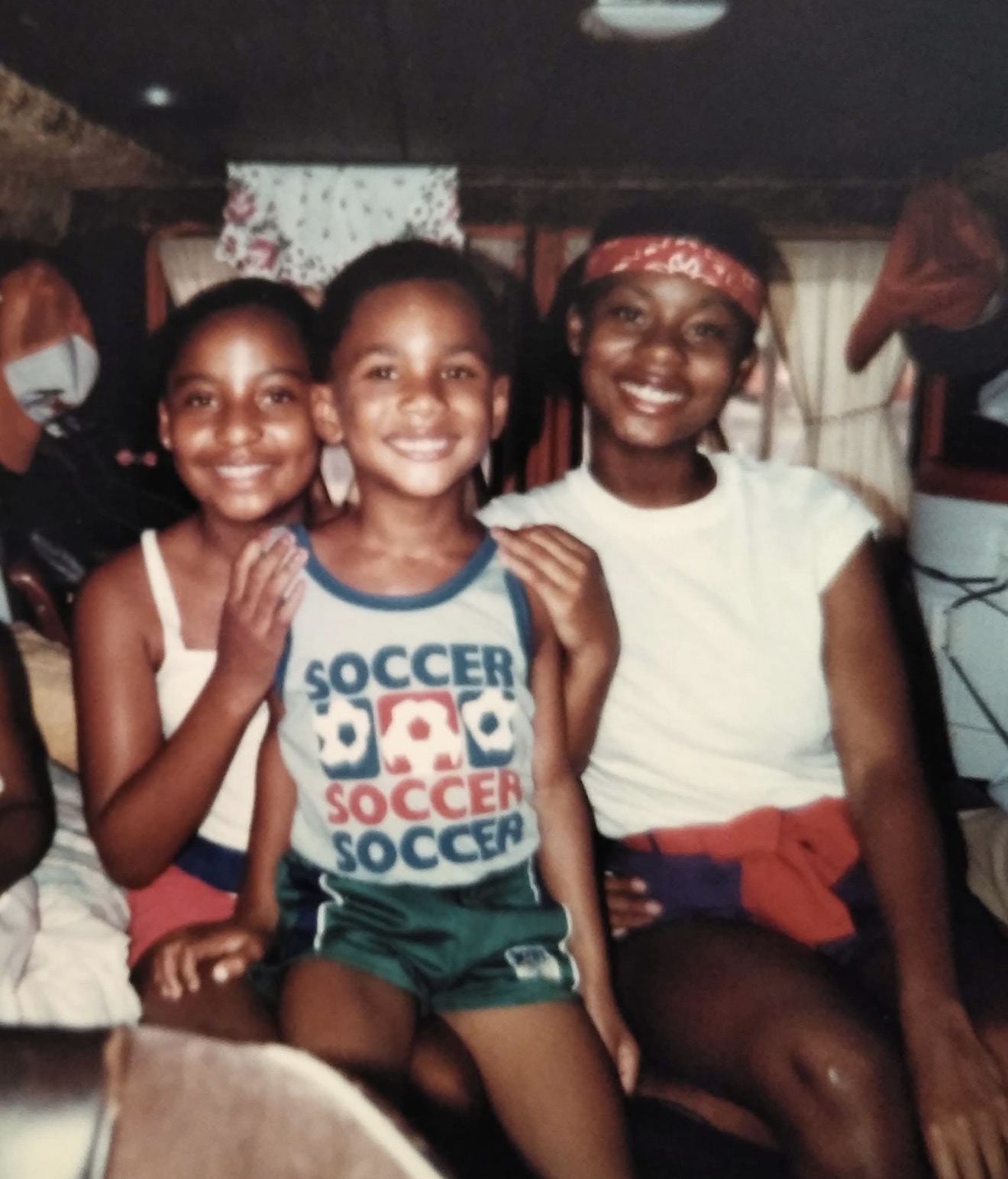Three young Knighton family members smiling together