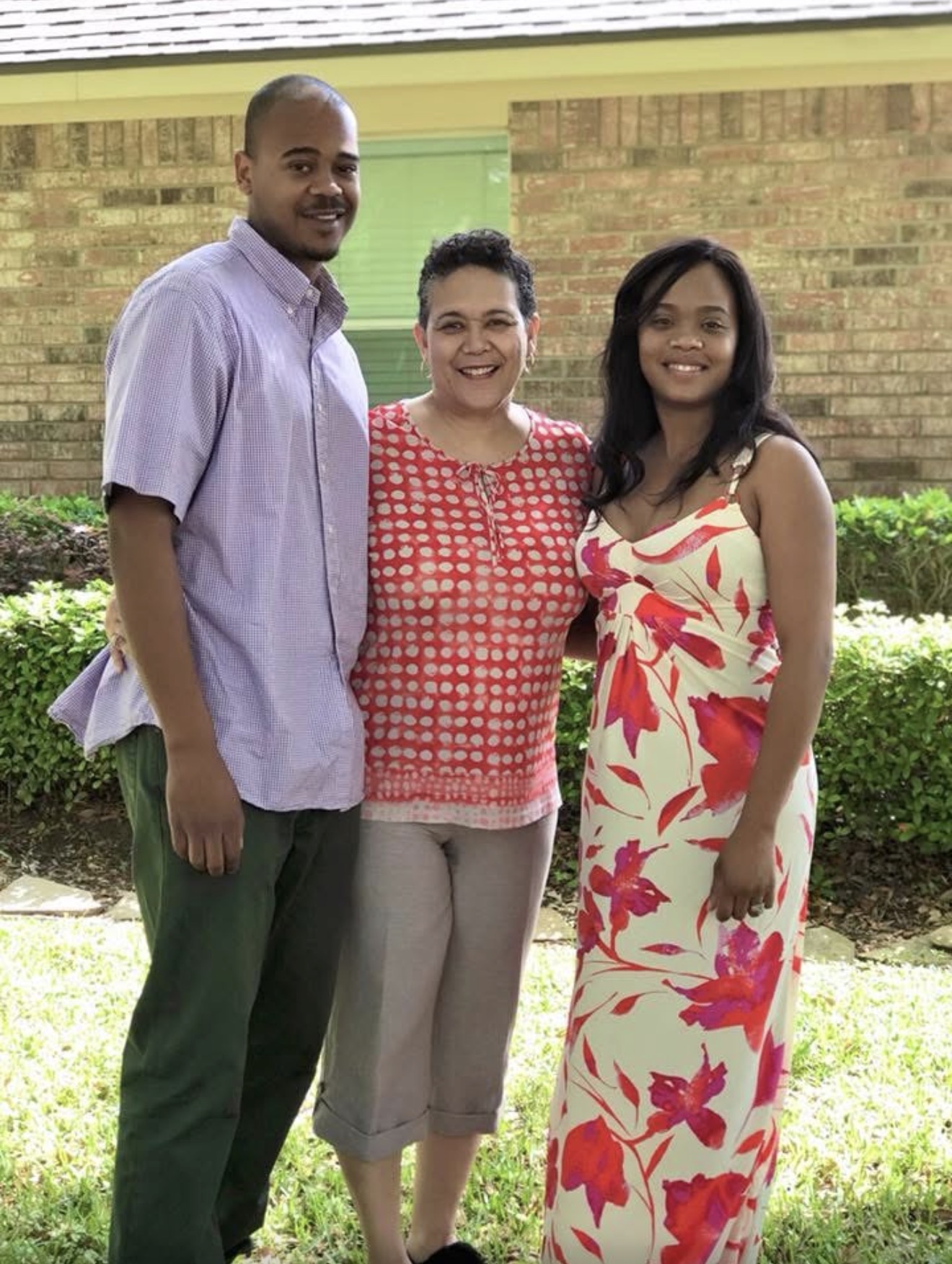 Knighton mother with her son and daughter outside their home