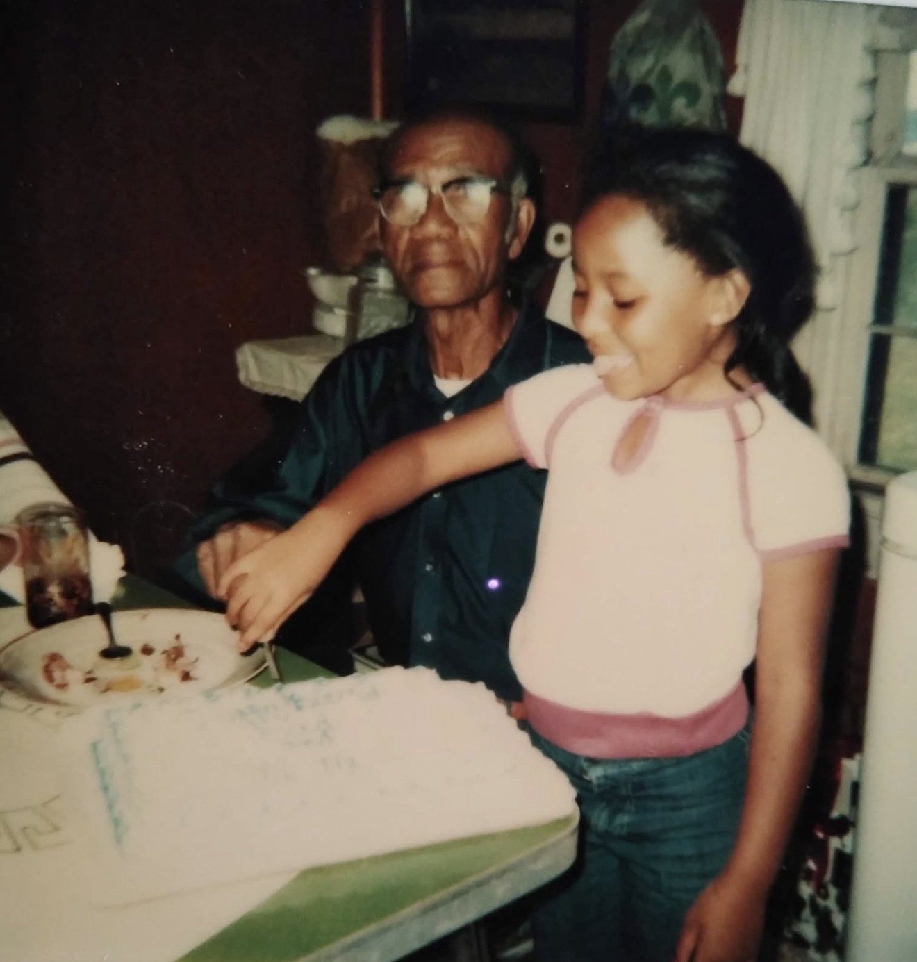 Grandfather and granddaughter at a birthday celebration